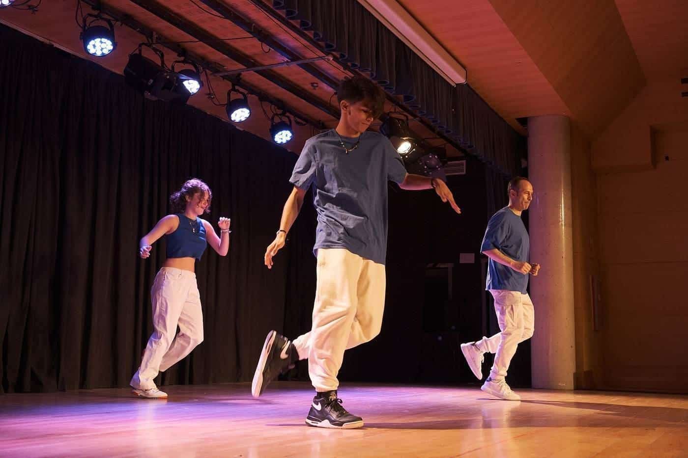 Shuffle dancers performing on a stage under coloured lights
