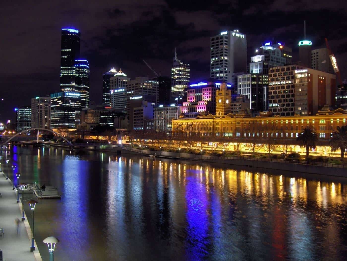 The Melbourne city skyline lit up at night across the river